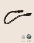 Load image into Gallery viewer, Black leather strap with crystal embellishments on a beige background

