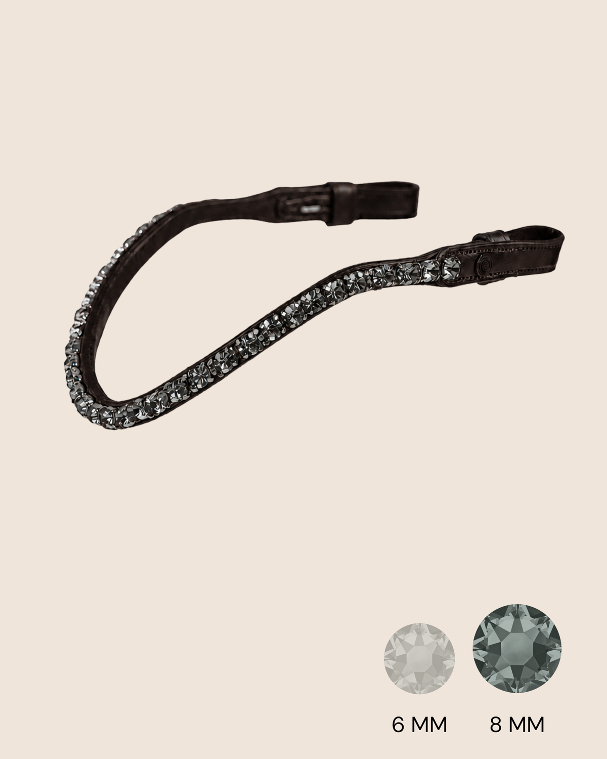 Black leather strap with crystal embellishments on a beige background