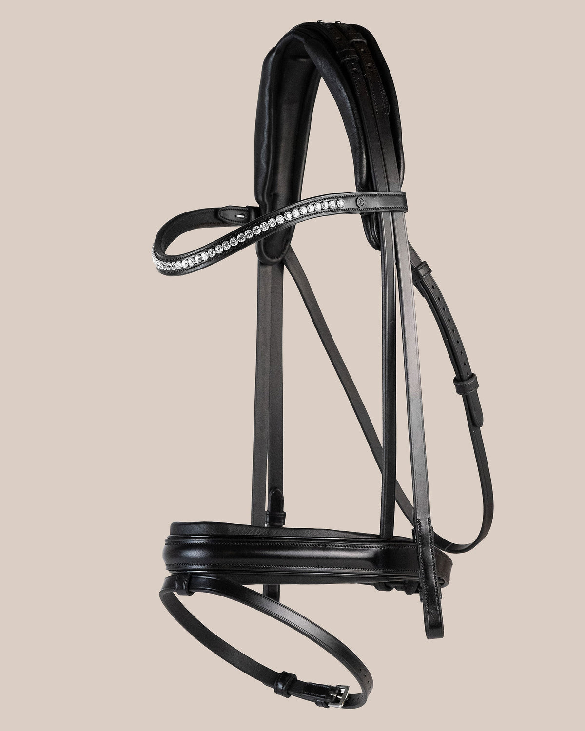 Black horse bridle with decorative elements on a beige background
