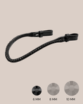 Load image into Gallery viewer, Black leather strap with crystal embellishments on a beige background

