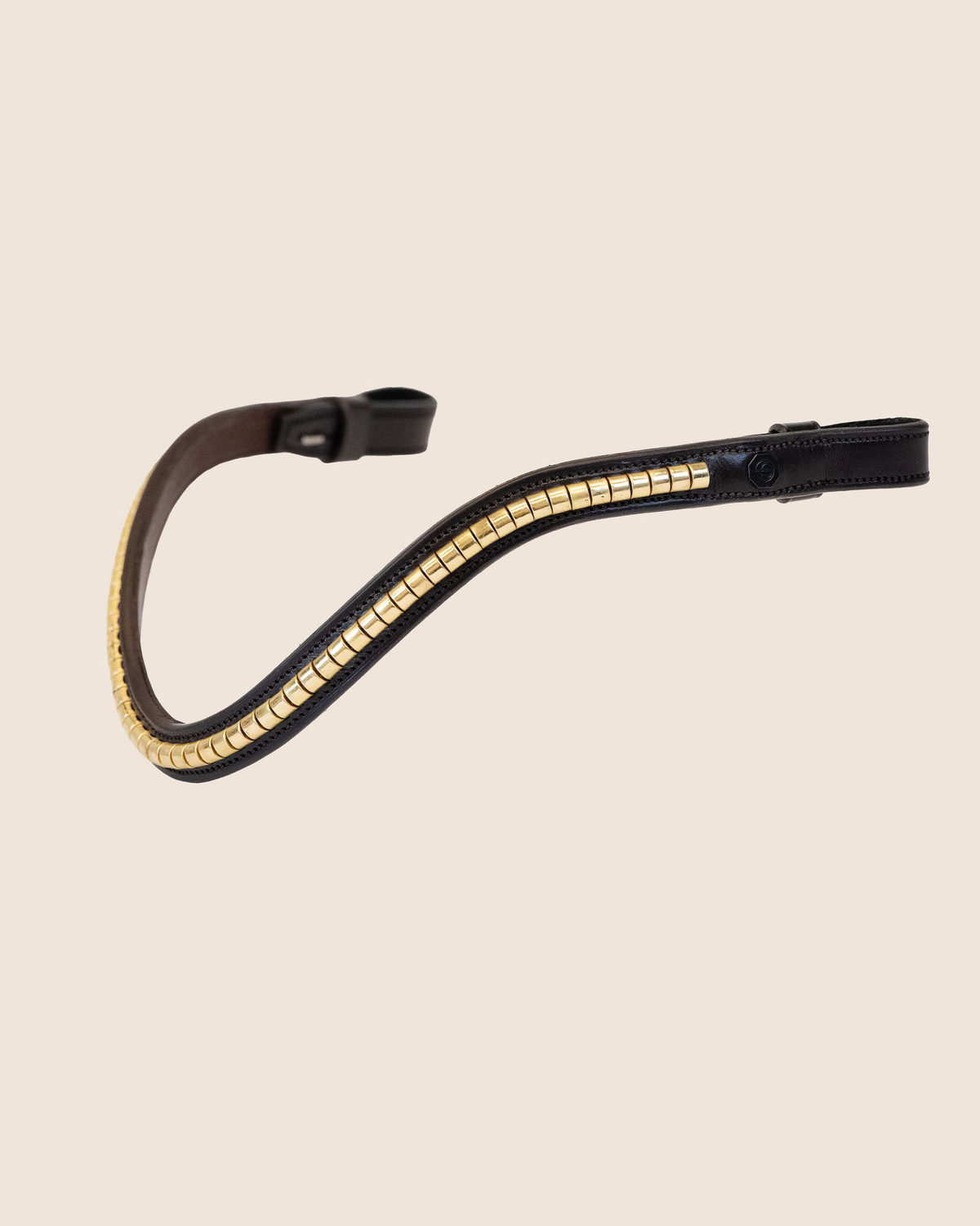 Black leather browband with gold accents on a beige background