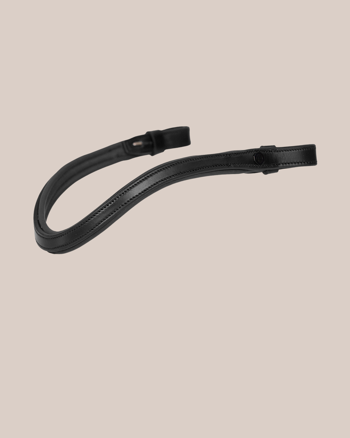 Black leather strap on a beige background
