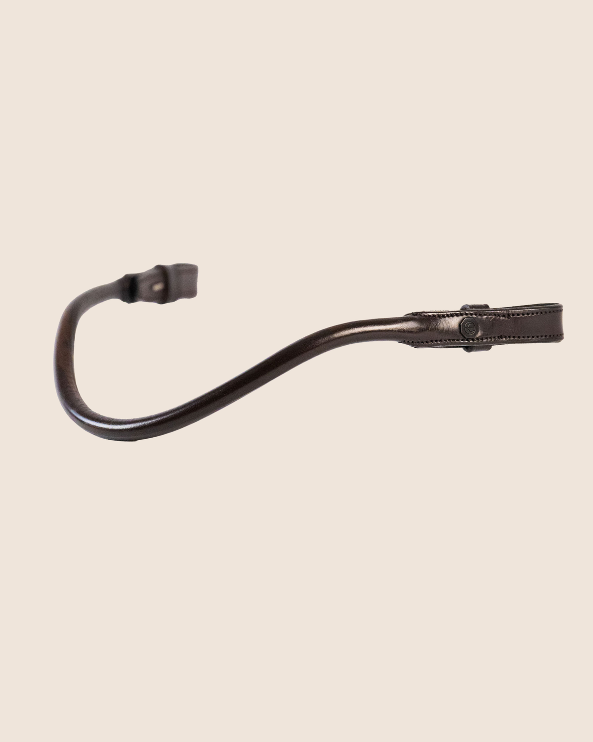 Black leather strap on a beige background