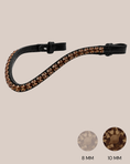 Load image into Gallery viewer, Black headband with brown rhinestones on a beige background
