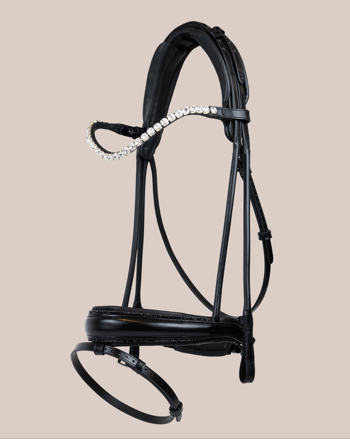 Black leather bridle with decorative elements on a beige background