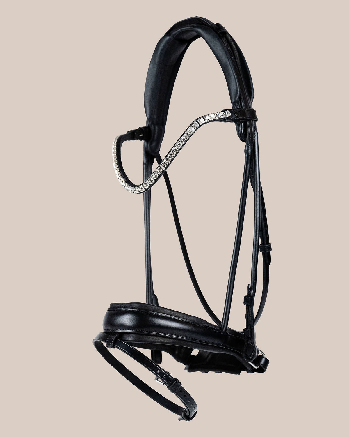 Black horse bridle with decorative elements on a beige background